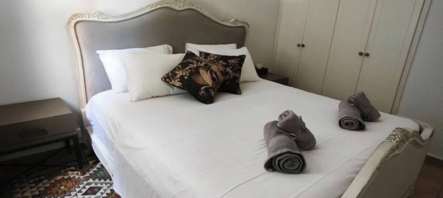A spacious apartment with one bedroom and a living room. in Paphos