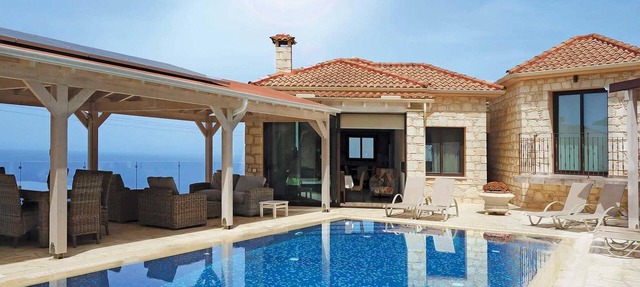 This attractive stone villa is set in an elevated position and commands wonderful views across the c in Paphos